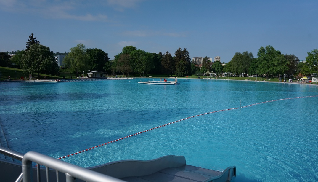 Breitrutsche und Schwimmbecken mit Insel in der Mitte im Freibad Weyermannshaus